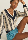 THE UPSIDE women's cream and navy check Sonny V Neck Sweater is a classic V neck knit in organic cotton. The perfect wardrobe addition.