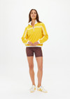 THE UPSIDE women's recycled fabric Prix Dawson Run Jacket in mimosa yellow is light and breathable whilst being water resistant and moisture wicking. Large back pocket with zip makes stow away and packing easy.