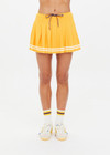 THE UPSIDE women's mimosa yellow recycled fabric Prix Quinny Pleated Skirt features a inner spin short with pockets and elasticated drawcord waist. Made for tennis.