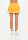 THE UPSIDE women's mimosa yellow recycled fabric Prix Quinny Pleated Skirt features a inner spin short with pockets and elasticated drawcord waist. Made for tennis.