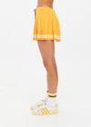 THE UPSIDE women's mimosa yellow recycled fabric Prix Quinny Pleated Skirt features a inner spin short with pockets and elasticated drawcord waist. Made for tennis.