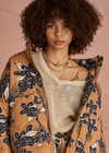 THE UPSIDE women's floral Aruba Quilted Nicola Jacket is designed for an oversized fit and features patch pockets and antique brass zipper. Made for lifestyle.