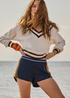 THE UPSIDE women's white organic cotton Josette V Neck Knit Sweater features a striped cable neckline in orange and navy. Made for everyday leisure.