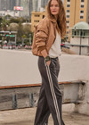 THE UPSIDE women's brown recycled fabric Vegan Leather Twilight Pant features an elasticated waistband with contrast white binds down the side. The perfect addition to your everyday wardrobe.