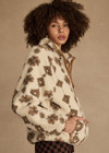 THE UPSIDE women's beige recycled fleece fabrication Harlow Fleece Pullover is a relaxed pullover style with quarter zip through and zip pockets.