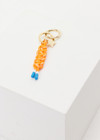 THE UPSIDE women's Orange Limitless Keyring charm with gold metal star and macrame paracord in bright orange with rubber dipped ends.