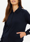 THE UPSIDE women's black Empire Pari Zip Jacket fits true-to-size and features a zip-through opening and knitted cream stripes down sides with a hint of silver metallic. Made for lifestyle.