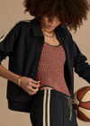 THE UPSIDE women's black Empire Pari Zip Jacket fits true-to-size and features a zip-through opening and knitted cream stripes down sides with a hint of silver metallic. Made for lifestyle.