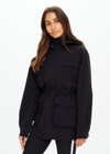 THE UPSIDE women's black Freddie Fleece Lined Anorak is made from bonded water resistant fabric with internal warm polar fleece and features external pockets with flap closure and drawcord with toggles to cinch in waist.