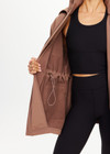 THE UPSIDE women's brown Freddie Fleece Lined Anorak is made from bonded water resistant fabric with internal warm polar fleece and features external pockets with flap closure and drawcord with toggles to cinch in waist.
