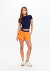 THE UPSIDE women’s orange recycled fabric Elixir Lucky Run Short is designed for a relaxed fit and features an elasticated waistband and curved hem. Ideal for running.