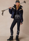 THE UPSIDE women’s navy Hakuba Fox Puffer Jacket is a true-to-size fit, featuring a water-resistant coating, fringed detailing, fleece-lined zip pockets and an adjustable elastic at hem. Designed for Après-ski and winter wear.