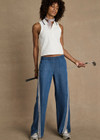 THE UPSIDE women’s white Henri Collared Top, in a cotton pique fabrication, features buttons at the front neck with a ribbed collar in a navy stripe. Designed for tennis.