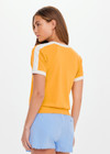 THE UPSIDE women’s yellow organic cotton Daisy Salome Tee has a regular fit with a soft ribbed neckline and cream contrast panels on the shoulders. Made for lifestyle.