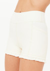 THE UPSIDE women’s cream recycled peached Volant 3inch Spin Short is designed for a soft & supportive fit and features pockets and a ruffle frill at hem. Made for yoga & pilates.