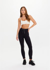 THE UPSIDE women’s black recycled peached Celestia 25inch Legging is a soft & supportive fit and features a drawcord and printed star and horseshoe on ankles. Made for yoga & pilates.