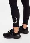 THE UPSIDE women’s black recycled peached Celestia 25inch Legging is a soft & supportive fit and features a drawcord and printed star and horseshoe on ankles. Made for yoga & pilates.