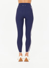 THE UPSIDE women’s navy recycled peached Samara 25inch Legging is a soft & supportive fit and features side pockets and contrast cream stripes with curved hem detail. Made for pilates.