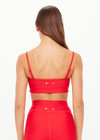 THE UPSIDE women's red eco tech Oxford Hutton Scoop Bra offers support and comfort with cream side stripes, adjustable straps, removable cups, and shelf bra. Made for high impact.