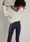 THE UPSIDE women’s cream organic cotton Espada Louie V Neck Sweater is a regular, chunky cable knit design with a navy and rose striped neckline. Made for everyday.