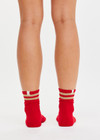 THE UPSIDE women’s red Curio Crew Sock with jacquard stripes in gold metallic yarn.