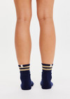 THE UPSIDE women’s navy Curio Crew Sock with jaquard stripes in gold metallic yarn.