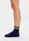 THE UPSIDE women’s navy Curio Crew Sock with jaquard stripes in gold metallic yarn.
