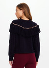 THE UPSIDE women’s navy Clara Tassle Knit Sweater is a relaxed, cable knit design featuring knotted tassels on front and back. Designed for Après-ski and winter wear.