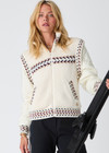 THE UPSIDE women’s cream Swiss Dhemi Knit Jacket features a zip through opening, removable sleeves and is lined with polar fleece. Designed for Après-ski and winter wear.