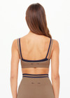 THE UPSIDE women’s recycled Form Seamless Kelsey Bra is a double-layer mocha bra with navy contrast and moisture control. Made for yoga and pilates.