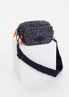 THE UPSIDE women’s navy recycled fabric Starlet Voyage Crossbody Bag features multi pockets with paracord zip pullers in our starlet ditsy print.