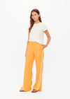 THE UPSIDE women’s lightweight yellow Juliet Pant features a low-rise fit with contrast binds and split hem detail. Perfect for travel and everyday wear.