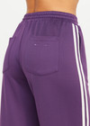 THE UPSIDE women's purple recycled Roma Pant is high-waisted with a drawcord, coated metal aglets, and side seam pockets. Perfect for travel or lifestyle.