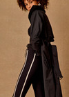 THE UPSIDE women's black James Hooded Trench Coat is a waterproof long line coat and features a fold-a-way hood, magnetic snap closures, an adjustable waist belt and external pockets. The perfect everyday coat.