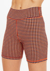 THE UPSIDE women's orange & navy check Solaris 5inch Spin Short is mid-rise and features an embroidered arrow logo at back. Made for yoga & pilates.