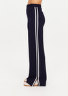 THE UPSIDE women's navy Monte Carlo Freya Knit Pant fits true-to-size and features an elasticated waistband with belt and knitted white side stripes. Made for lifestyle.