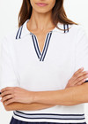THE UPSIDE women's white tennis, pickleball & padel Archie Collared Knit Polo is made from organic cotton and features navy & dusty blue striped ribbing at front placket, collar and hem.