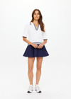 THE UPSIDE women's white tennis, pickleball & padel Archie Collared Knit Polo is made from organic cotton and features navy & dusty blue striped ribbing at front placket, collar and hem.
