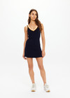 THE UPSIDE women's white organic cotton tennis Riley Knit Dress is designed for a slim fit and features wide straps and a V neckline with white stripes down the side.