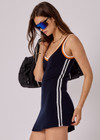 THE UPSIDE women's white organic cotton tennis Riley Knit Dress is designed for a slim fit and features wide straps and a V neckline with white stripes down the side.