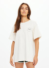 THE UPSIDE women's cream organic cotton Molokai Sammi Tee offers a oversized fit and features a green printed palm logo on front chest and back. Made for lifestyle.