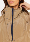 THE UPSIDE women's brown Rylan Anorak is relaxed fit, mid-length, made from tan wrinkled water-resistant fabric. Made for lifestyle.