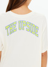 THE UPSIDE women's natural organic cotton Isadora Sammi Tee is designed for an oversized fit and features a printed logo in lime and blue with a soft rib neckline. Made for lifestyle.