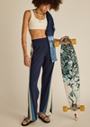 THE UPSIDE women's navy Lenzing viscose Petra Flare is designed for a true-to-size fit and features flare pants with splits and contrast chevron tape down side seams. Made for lifestyle.