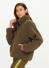 THE UPSIDE women's green recycled polyester Harlow Fleece Pullover is designed for a relaxed fit and features a quarter snap button opening and zip pockets. Made for lifestyle.