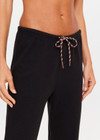 THE UPSIDE women's black organic cotton Kayne Track Pant is a classic mid-rise track pant and features a soft elasticated waistband with a brown paracord drawcord, elasticated cuffs and finished with a subtle embroidered arrow logo at back. The perfect everyday track pant, made to last.