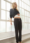 THE UPSIDE women's black organic cotton Kayne Track Pant is a classic mid-rise track pant and features a soft elasticated waistband with a brown paracord drawcord, elasticated cuffs and finished with a subtle embroidered arrow logo at back. The perfect everyday track pant, made to last.