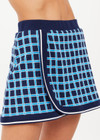 THE UPSIDE women's navy and blue plaid cotton Clubhouse Reece Mini Skirt is designed as a faux wrap skirt featuring a soft elastic waistband and a curved hemline. Made for tennis, golf & pickleball.