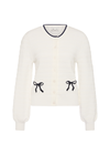 THE UPSIDE women's cream Jolie Isabeli Knit Cardigan is a regular fit with a blouson sleeve crafted from a pointelle knit and features navy embroidered bows. Made for tennis, golf & pickleball.