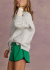 THE UPSIDE women's green recycled Austen Run Short made from quick drying performance fabric features a curved hem with cotton lace scalloped edge detailing, navy in-built shorts and invisible zip pockets. Made for running, tennis, golf & pickleball.